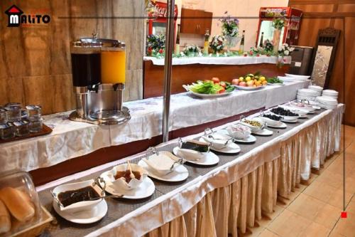 a buffet line with plates and bowls of food at Malito in Erbil