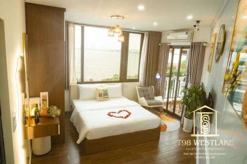 a bedroom with a bed with a heart on it at T98 Westlake Apartment in Hanoi