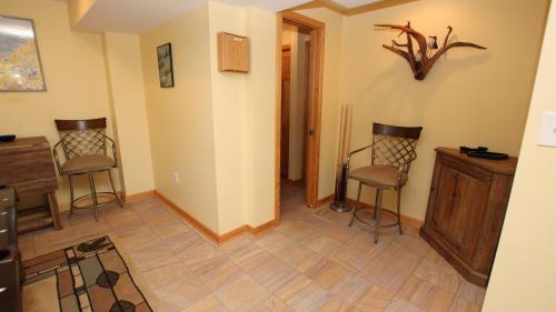 a living room with two chairs and a wooden floor at Oceanside, Ocean and Sound Views, Sun Decks, Rec Rm, SEA12, Farrview in Duck
