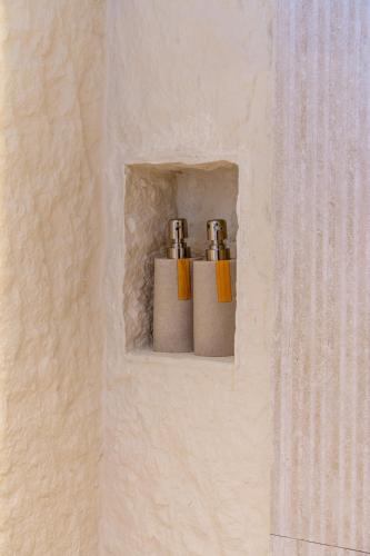 two salt and pepper shakers sitting on a wall at Pura Eco Retreat, Jebel Hafit Desert Park in Al Ain