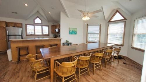 a kitchen with a large wooden table and chairs at Oceanside, Private Pool, Community Pool, Sun Deck, SP8, Ole Duck Haven in Duck
