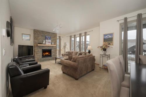 a living room with a couch and a fireplace at Trailhead Lodges Building 401 Unit 422 in Winter Park