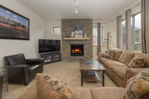 a living room with a couch and a fireplace at Trailhead Lodges Building 401 Unit 422 in Winter Park