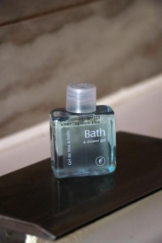 a bottle of balm sitting on a table at Rado Hotel - Quintanas in Trujillo