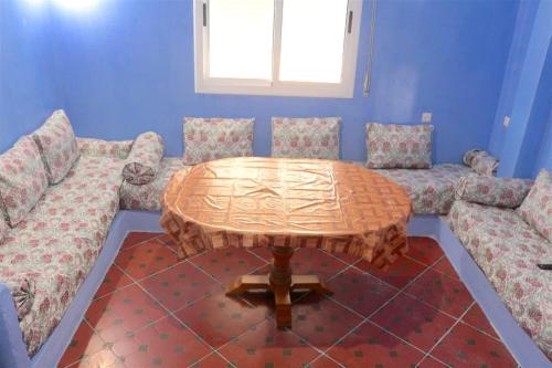 a living room with a table and two couches at Dar Khairoun with Balcony in Chefchaouene