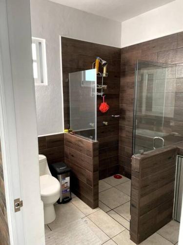 a bathroom with a toilet and a glass shower at Casa Lycha in Tlayacapan