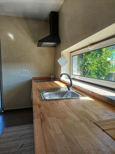 a kitchen with a sink and a window at A Casa do Soito in Oliveira do Hospital