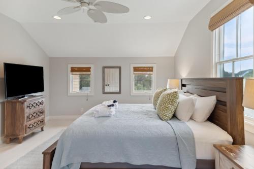 a bedroom with a large bed with a television at 1002 E Cooper The Folly Peach Beautiful Spacious House Steps from the beach in Folly Beach