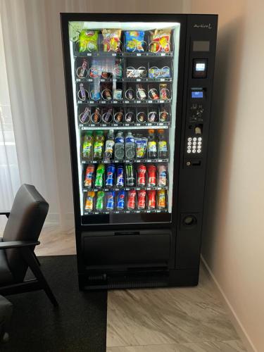 uma máquina automática de refrigerantes cheia de latas de refrigerante em Hotel Royal em Praga