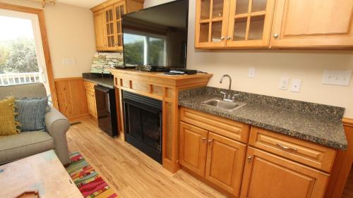 a kitchen with a sink and a counter top at Oceanside, Pool with Poolside Bar, Rec Room, Hot Tub, Sun Decks, SS8, Group Therapy in Southern Shores
