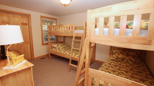 a bedroom with two bunk beds in a house at Oceanside, Pool with Poolside Bar, Rec Room, Hot Tub, Sun Decks, SS8, Group Therapy in Southern Shores