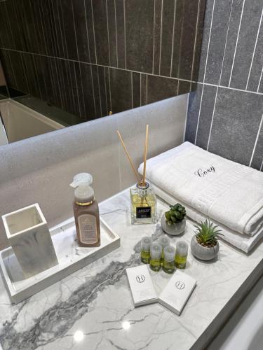 a bathroom with a counter with a towel and cosmetics at Urban Luxury Accomodation - Cozy Apartments at Coresi Mall #Brasov in Braşov