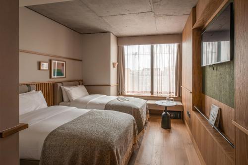 a hotel room with two beds and a window at Wren Urban Nest in Dublin