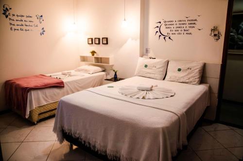Ένα ή περισσότερα κρεβάτια σε δωμάτιο στο Pousada Emcanto