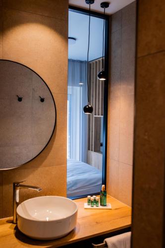 a bathroom with a sink and a large mirror at Boardinghouse Hense in Lingen