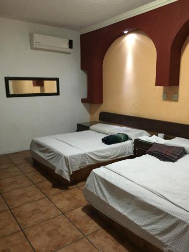 a hotel room with two beds in a room at Hotel Xalapa in Veracruz