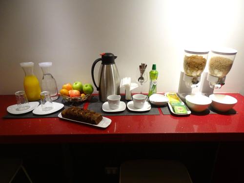 a red counter top with a bunch of food on it at BHB Hotel Boutique in Santiago