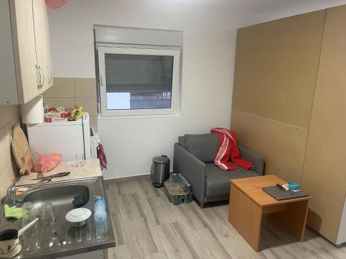 a living room with a couch and a chair at Stan 3 UB in Ub