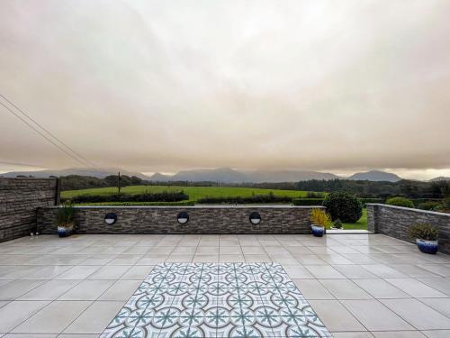a courtyard with a stone wall and a tile floor at Dunard house. in Tullaha
