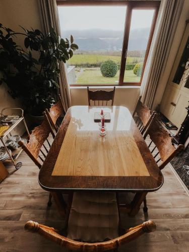 a table in a room with a large window at Dunard house. in Tullaha