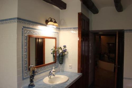 a bathroom with a sink and a mirror at Cal Forner in Santa Oliva