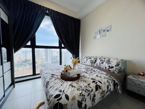 a bedroom with a bed and a large window at Urban Suites by PerfectSweetHome Cozy Style in Jelutong