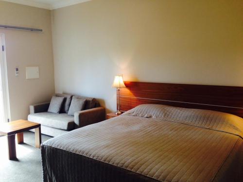 a hotel room with a bed and a couch at The York Palace Accommodation in York