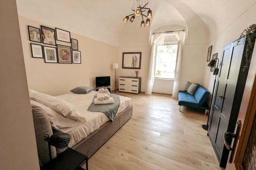 a bedroom with a bed and a blue chair at Love House sul mare in Cetara