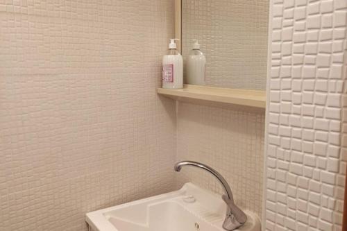 a bathroom with a sink and two bottles of soap at Love House sul mare in Cetara