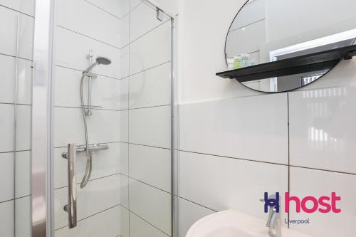 a glass shower in a bathroom with a sink at Host Liverpool - Gorgeous Anfield home in Liverpool