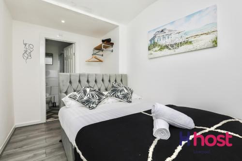 a bedroom with a bed with black and white pillows at Host Liverpool - Gorgeous Anfield home in Liverpool