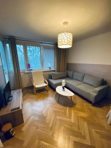 a living room with a couch and a table at ClickTheFlat Miła Center Apart Rooms in Warsaw