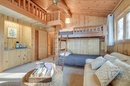 Cette chambre comprend un canapé et des lits superposés. dans l'établissement Cozy Lakefront Cabin in Semora with Large Dock!, à Semora