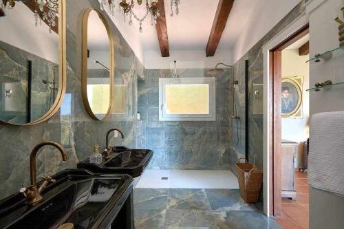 a bathroom with two sinks and a shower at Villa en Calonge con Gran piscina in Calonge