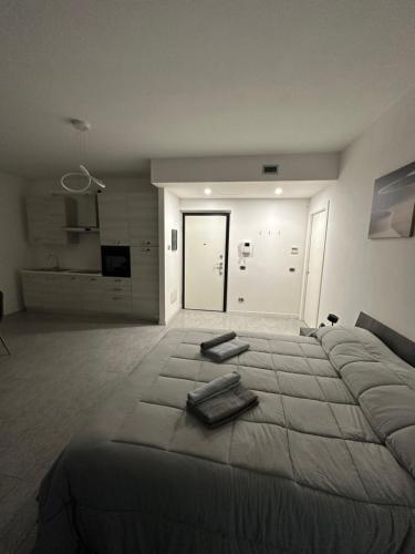 a bedroom with a large bed with two towels on it at ] DOMA [ in Inveruno