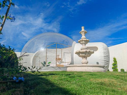 a fountain in front of a building with a glass dome at Hotel Wanderlive in Querétaro