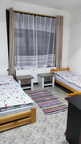 a room with three beds and a window at Nároďák Jaroměř ,UBYTOVÁNÍ in Jaroměř