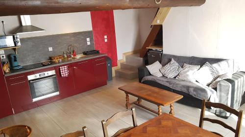 a living room with a couch and a table at Maison au sommet des montagnes in Boussenac