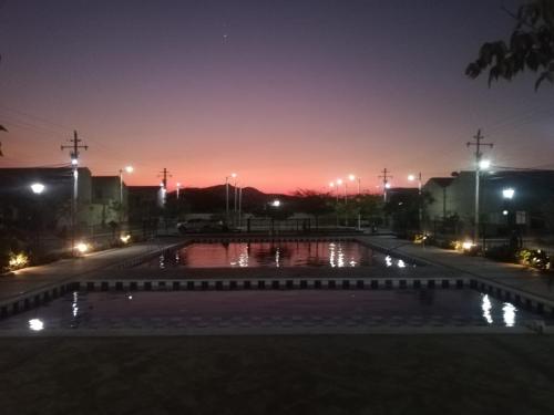 uma piscina de água à noite com luzes acesas em Hermosa casa en Santa Marta em Santa Marta