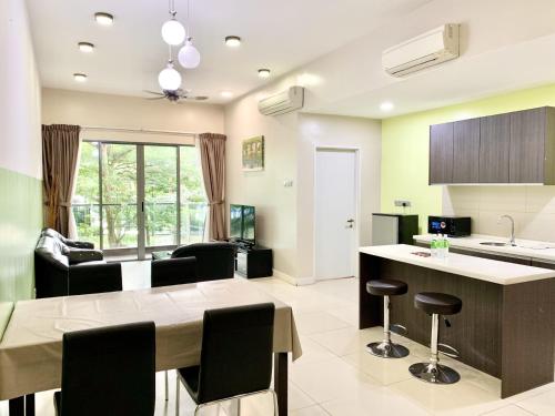a kitchen and living room with a table and chairs at Deco Home @ Imago The Loft in Kota Kinabalu