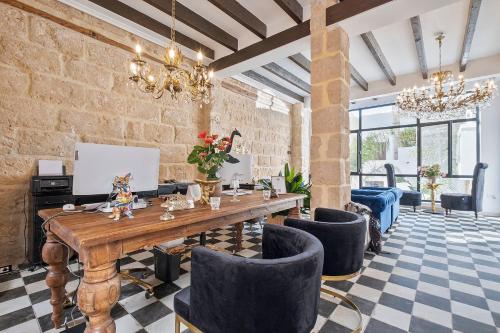 a large room with a wooden table and chairs at Ca Sana Teulada Moraira, Grupo Terra de Mar, alojamientos con encanto in Moraira