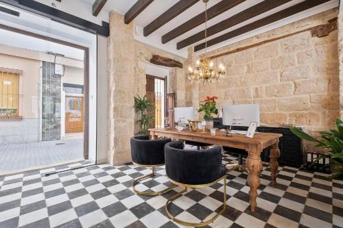 a dining room with a table and chairs at Ca Sana Teulada Moraira, Grupo Terra de Mar, alojamientos con encanto in Moraira