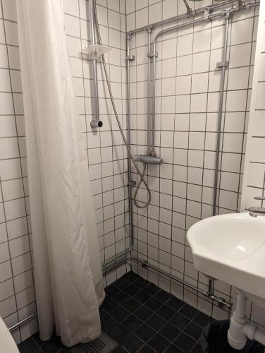 a bathroom with a shower and a sink at Stockholm Central- Near Drottninggatan & Shops! in Stockholm