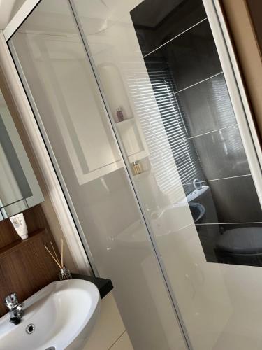 a bathroom with a sink and a shower at Playa la Casa in Lossiemouth