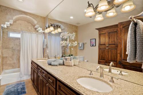 a bathroom with a sink and a large mirror at Luxury Tuscan Villa Near Old Town in Albuquerque