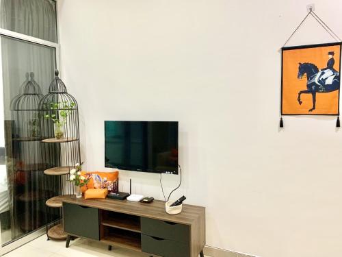 a living room with a tv on a white wall at Deco Home @ Imago The Loft in Kota Kinabalu