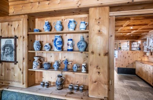 a room with shelves filled with blue and white vases at Berghotel Schlemmer in Bressanone