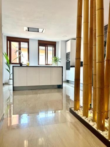 a kitchen with bamboo columns in a house at Casa con jacuzzi y piscina con vistas al castillo in Corbera de Alcira