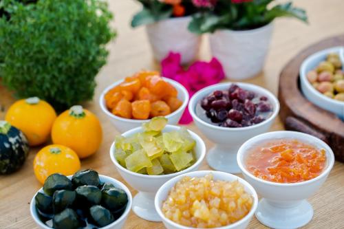 a table topped with bowls of different fruits and vegetables at Alacati Kapari Hotel - Special Category in Alacati