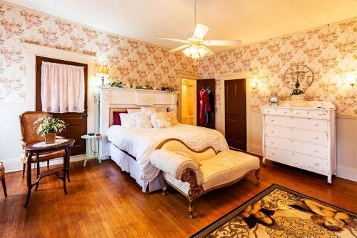 a bedroom with a bed and a ceiling fan at The Lancaster Manor Bed and Breakfast in Gainesville